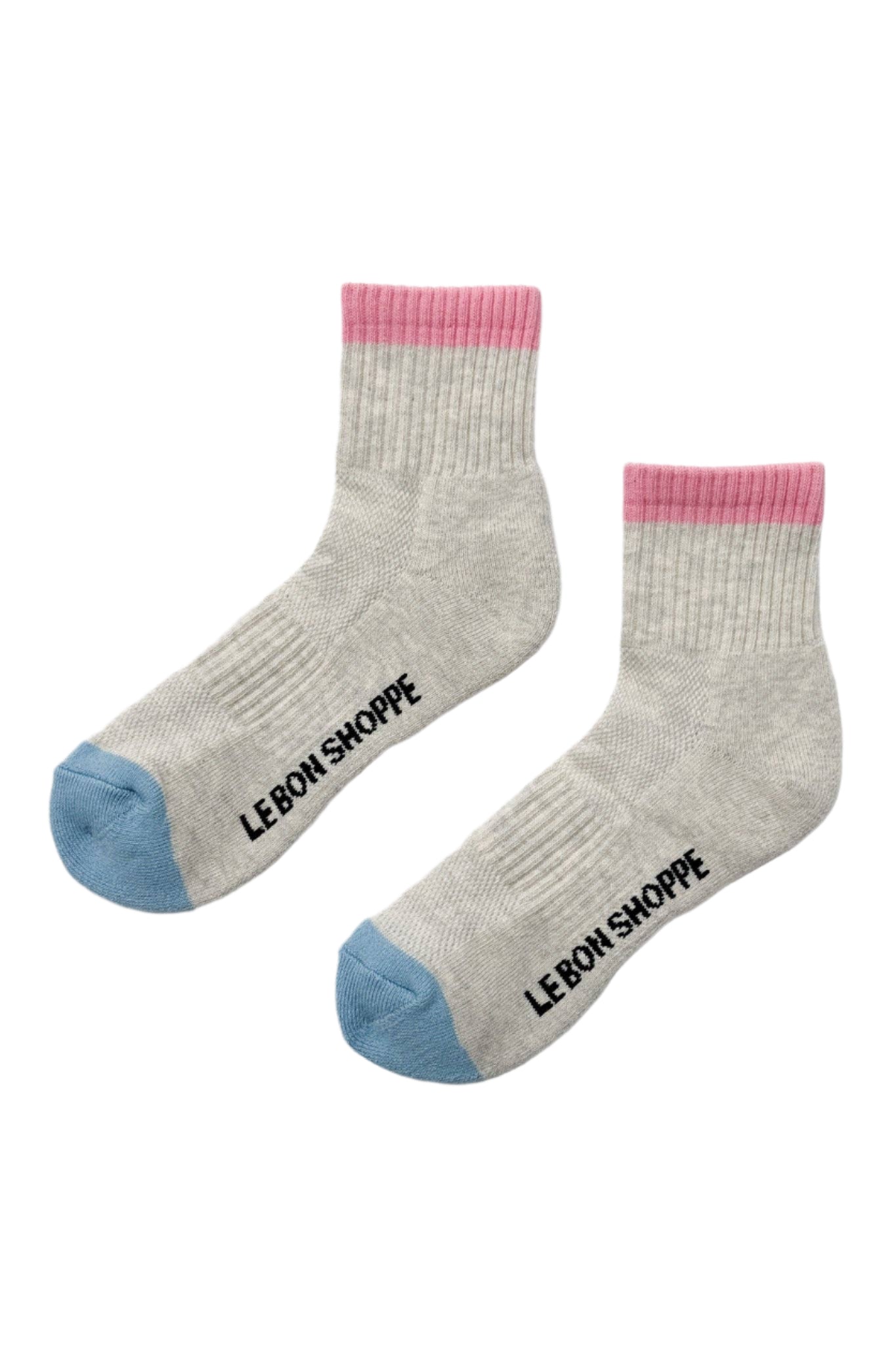 A pair of color block girlfriend socks with gray body and pink detailing on the ankle and toe.